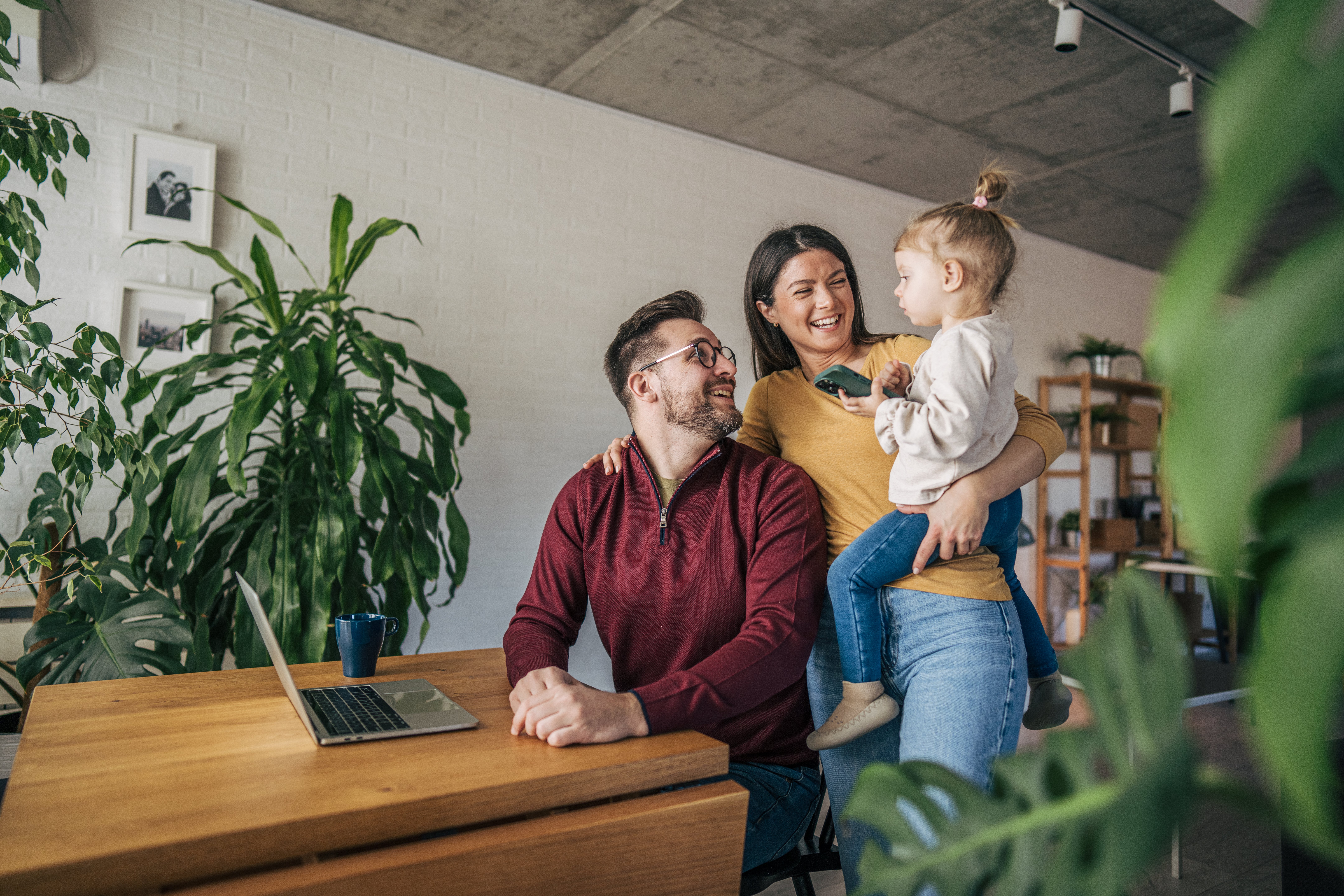 A businessman working from home with his family.
