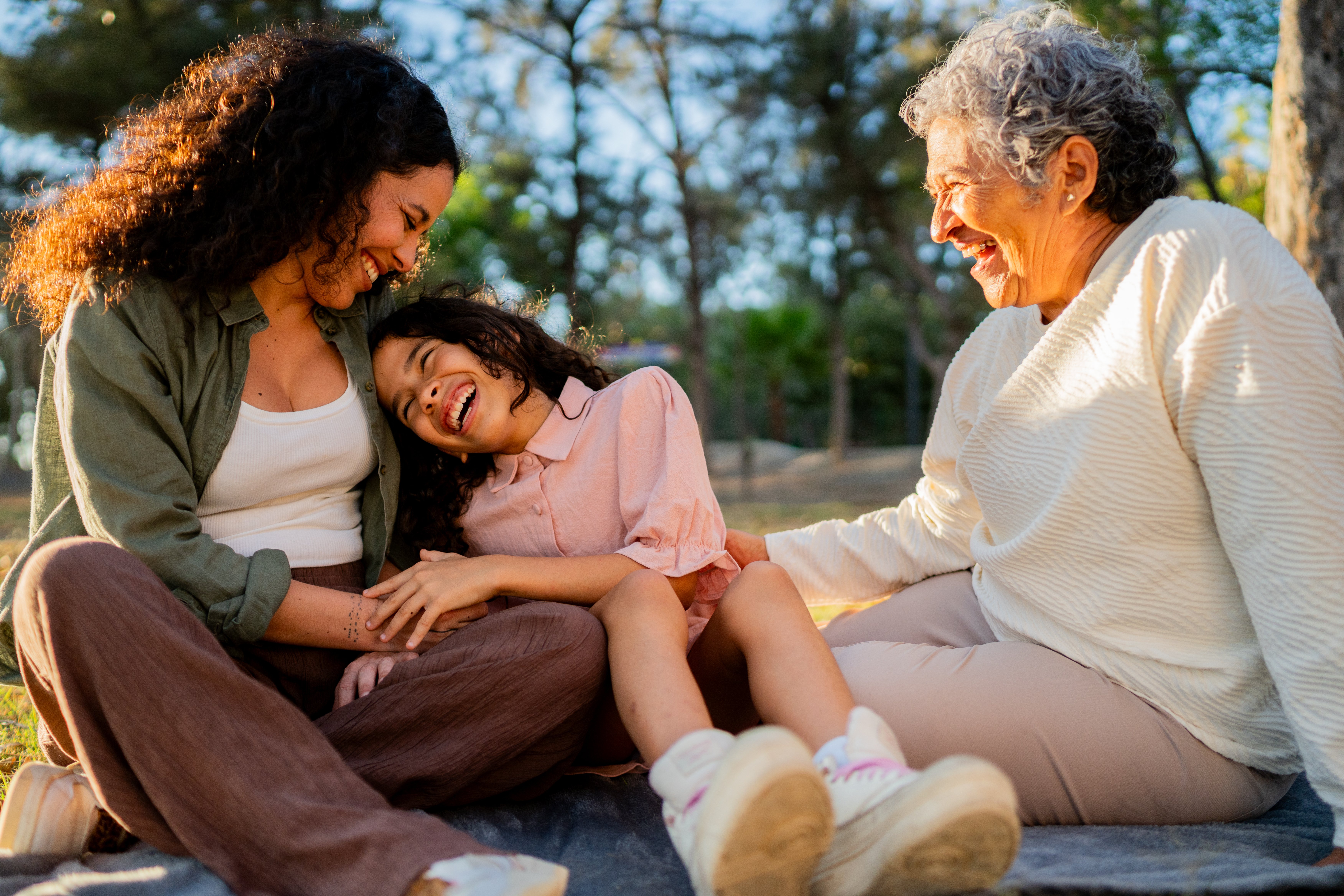 Mother, daughter, and grandmother at a picnic.