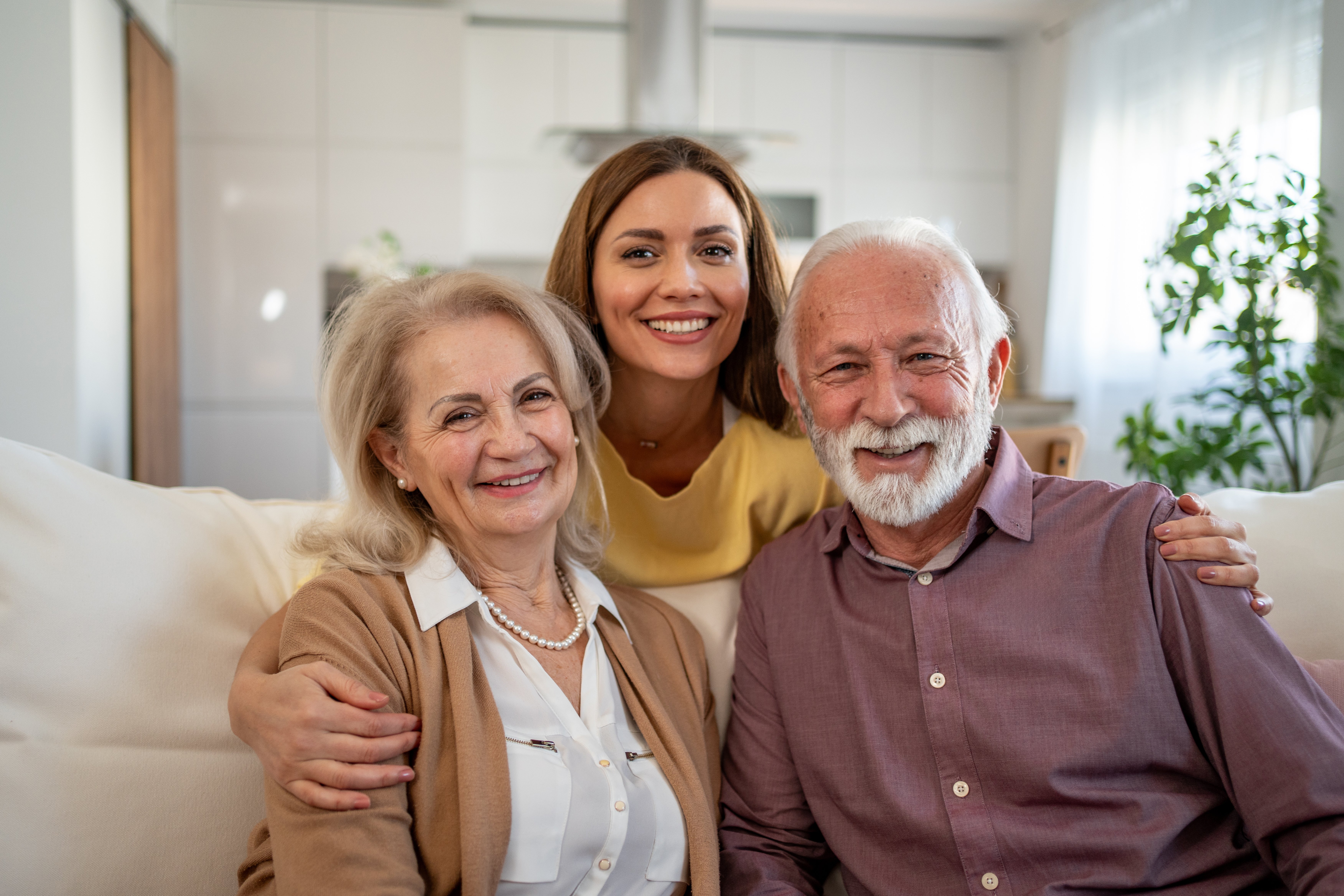 Multi-generational family sitting together smiling.