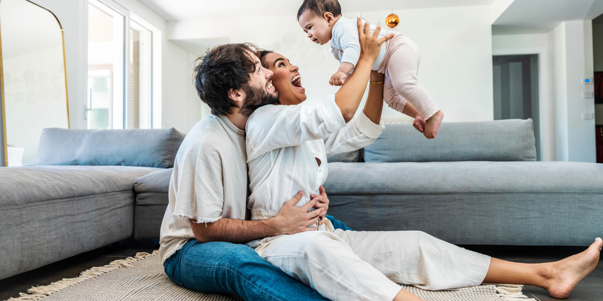 Husband and wife celebrating their growing family.