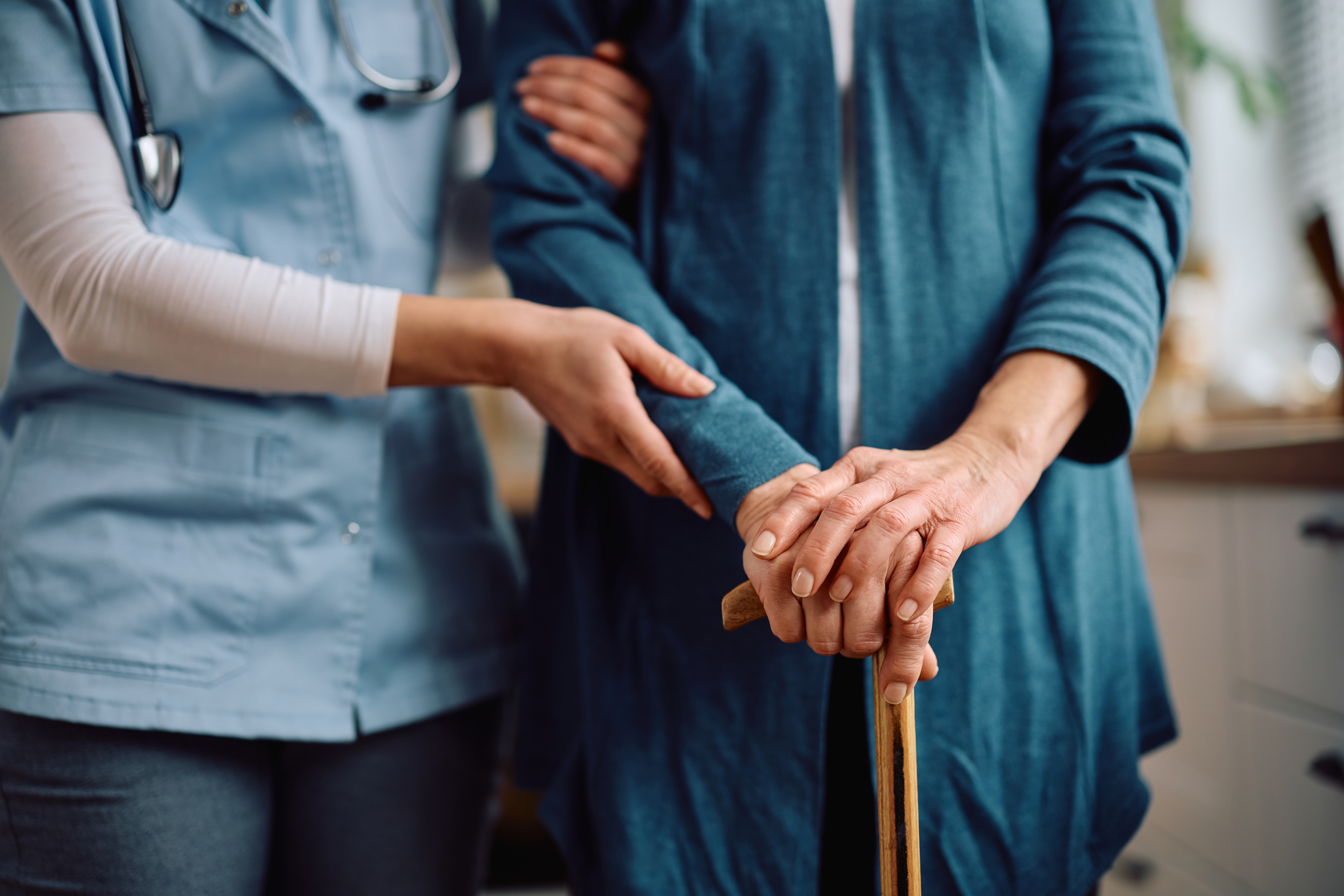 An elderly woman being taken care of by a nurse.